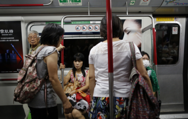 People are seen in a wagon of the Island line subway in Hong Kong