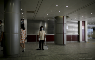 A cleaning woman stands in the Hong Kong Jockey Club in Hong Kong