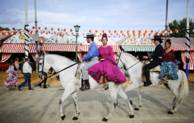 Riders wearing Andalusian outfits and women wearing sevillana dresses ride during the traditional Feria de Abril (April fair) in the Andalusian capital of Seville, southern Spain