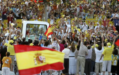 Pope Benedict XVI waves from the popemobile he arrives for the World Meeting of Families in Valencia
