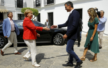 Spain's Prime Minister Pedro Sanchez greets German Chancellor Angela Merkel before a lunch as part of her informal two-day visit in Sanlucar de Barrameda