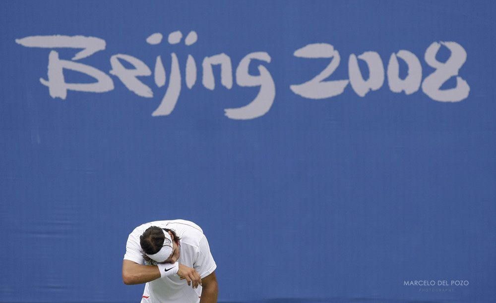 Spain's Nadal wipes his face as he attends a tennis practice session ahead of the Beijing 2008 Olympic Games