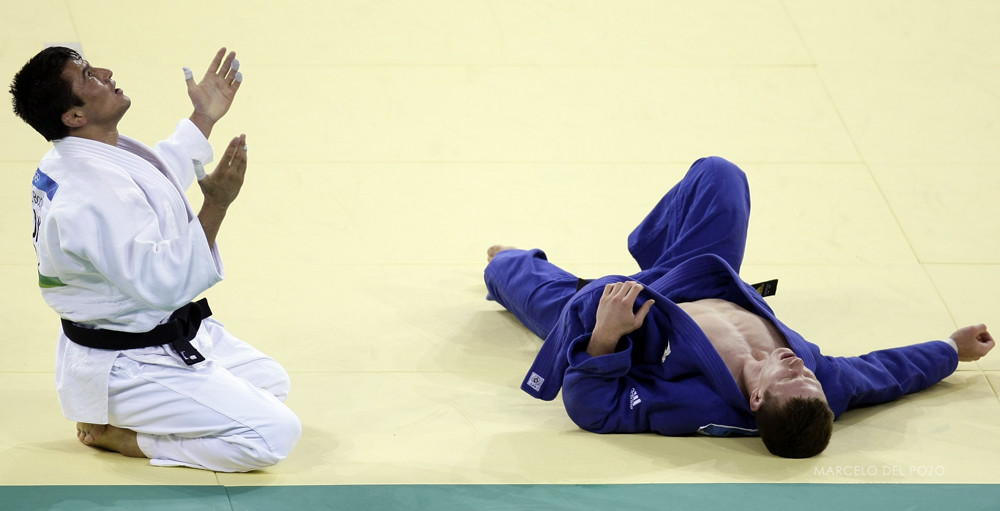 Boqiev of Tajikistan celebrates after defeating van Tichelt of Belgium during their men's -73kg final of the repechages judo match at the Beijing 2008 Olympic Games