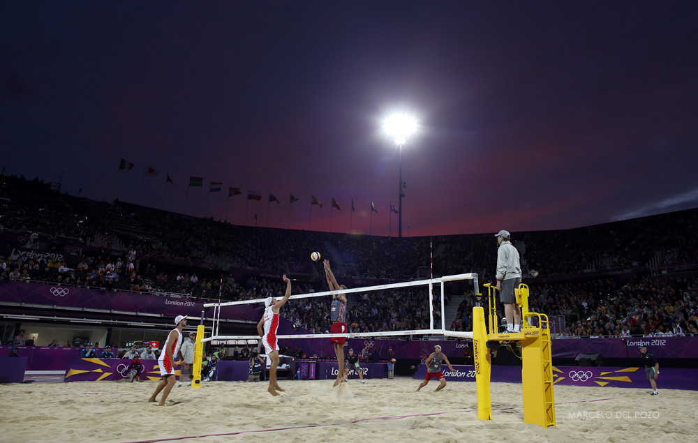 Switzerland's Sascha Heyer spikes the ball as Russia's Konstantin Semenov jumps to block it during their men's preliminary round beach volleyball match at the London 2012 Olympic Games at Horse Guards Parade