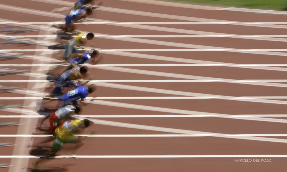 Athletes run during the men's 100 metres event at the Athens 2004 Olympic Games.