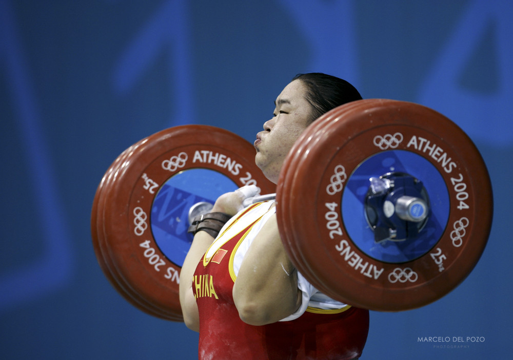 China's Tang Gonghong powers a lift in the women's +75 kg weightlifting event at the Athens 2004 ...