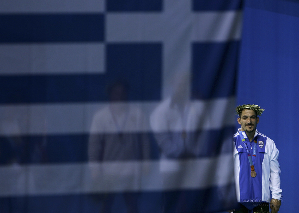 Greece's Pyrros Dimas stands on the podium in the men's 85 kg weightlifting event at the Athens 2004 ...