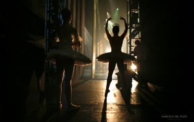 Ballet dancers from the English National Ballet warm up as they watch backstage the first act of "Cinderella" in Seville